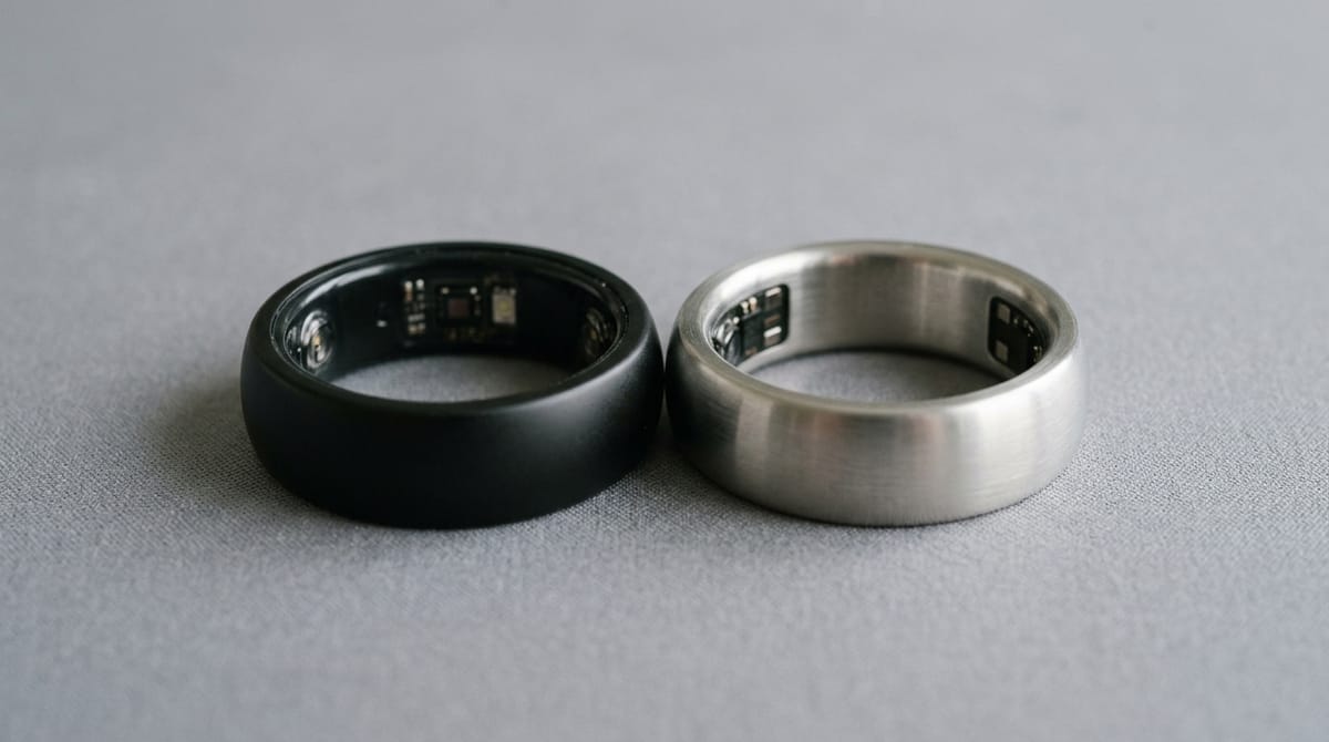 A black and a silver smart ring facing each other