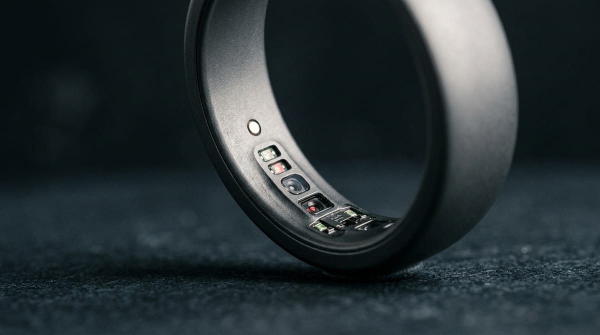 Extreme closeup of a matte grey smart ring showing inner sensors