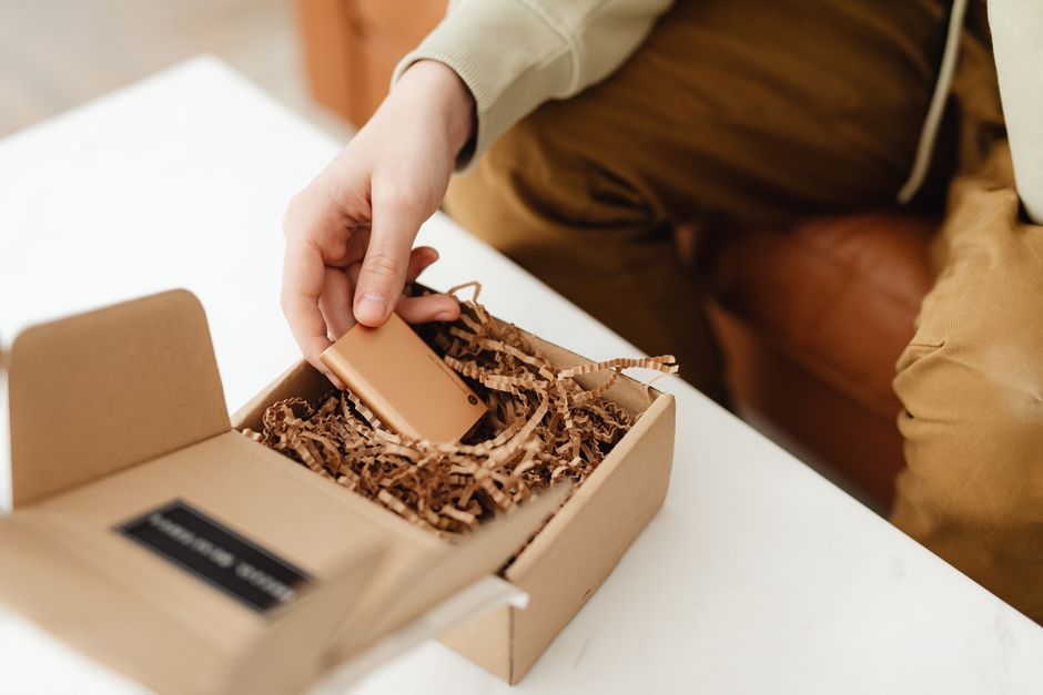 Hands opening a small product package